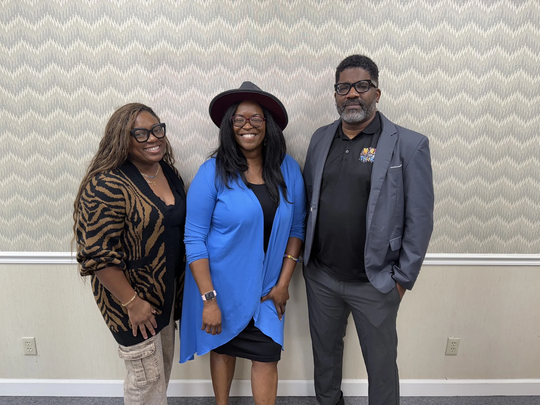 Three members of the More Than Therapy community standing together